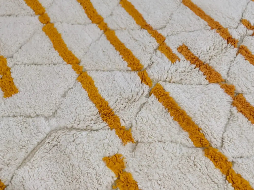 A plush white and mustard-yellow moroccan handmade beni ouarain rug with textured fluffy surface 248 x 158 cm