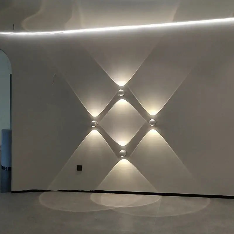 Modern white textured wall featuring decorbites™ moroccan modern black brass led wall lamp with recessed spherical lights arranged in diamond pattern