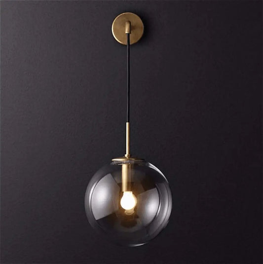 DecorBites™ Moroccan modern wall sconce light with a sleek clear glass globe and brass accents modern wall sconce