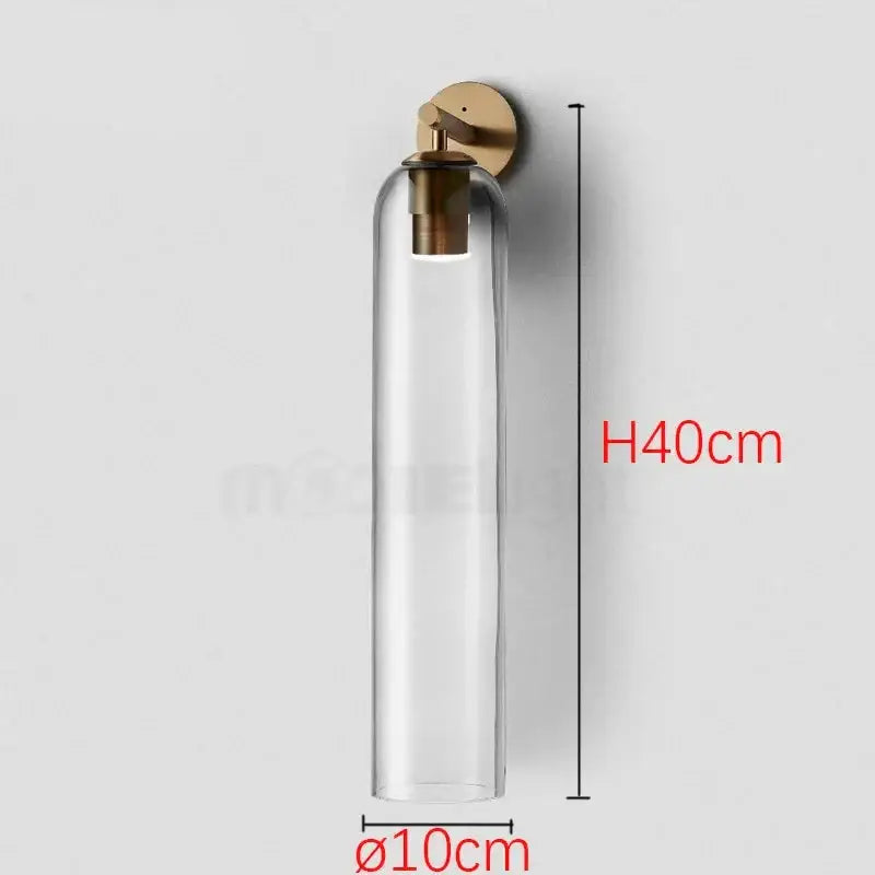 Sleek glass wall sconce by decorbites with clear cylindrical glass and brass finish designed for energy-efficient led bulbs
