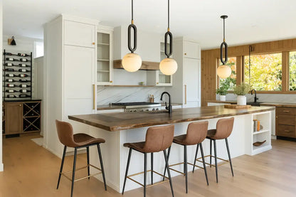 Brown leather bar stools with black metal legs and gold accents complementing decorbites™ white marble pendant light with led bulb
