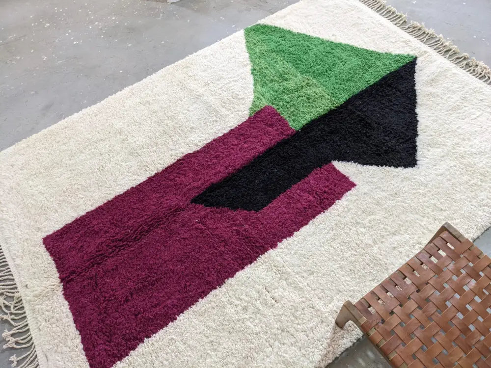 Cream-colored wool traditional azilal rug by decorbites with bold green black and burgundy geometric patterns 298x220cm