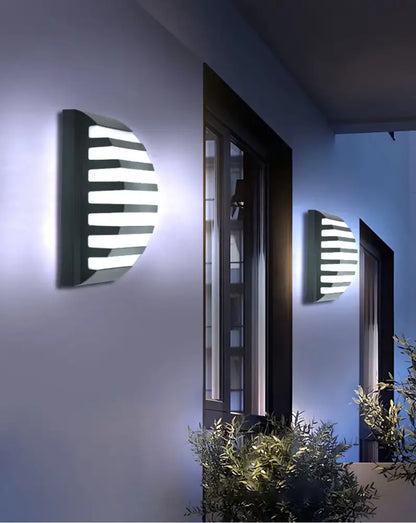 Modern black semi-circular outdoor wall light with horizontal white led strips and motion sensor by decorbites