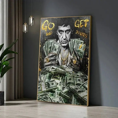 A framed canvas painting of scarface tony montana in black and gold holding stacks of money decorbites motivational art