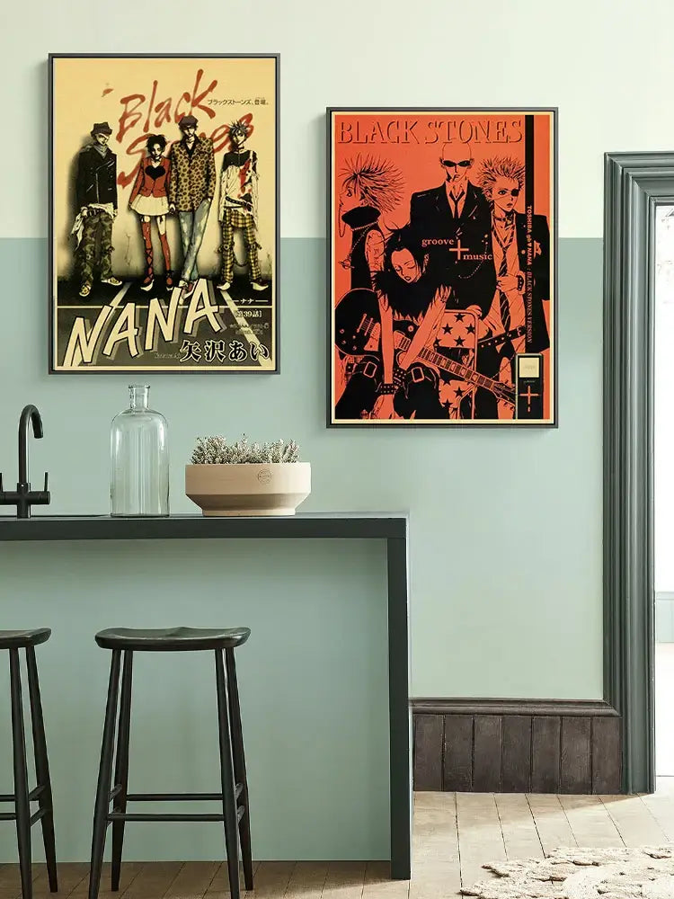 Two framed DecorBites™ NANA anime posters on retro kraft paper featuring black stones and nana characters above kitchen counter