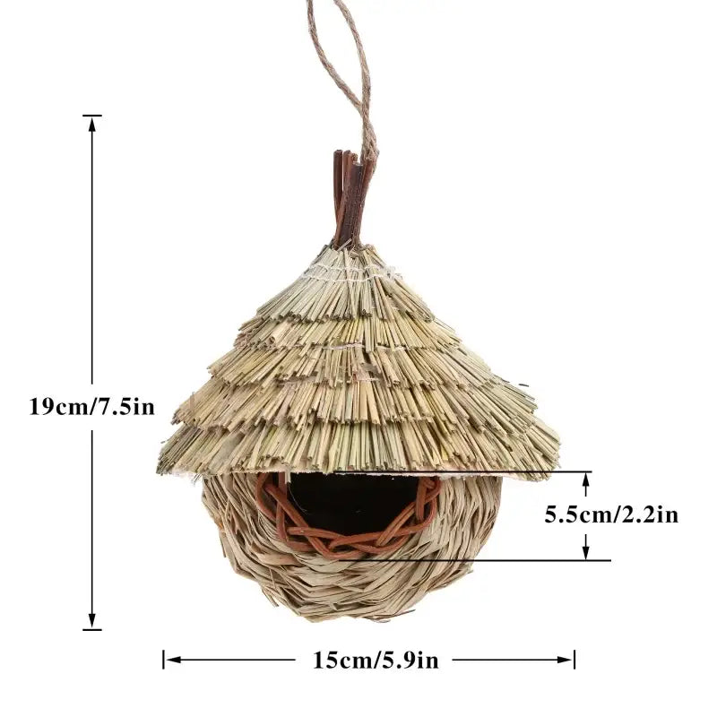 Handwoven natural grass bird cage with thatched roof and wooden dowels for hanging parrot nest by DecorBites