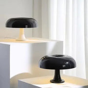 Black led mushroom table lamp with glossy finish and slender stem for modern hotel bedroom and living room decor