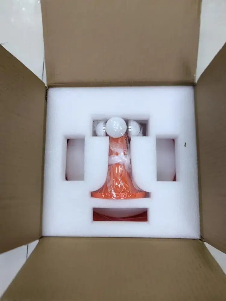 An orange and white led mushroom table lamp figurine with glossy finish wrapped in clear plastic for modern décor