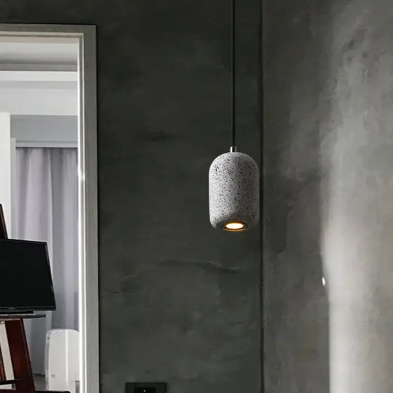 Decorbites™ nordic cement pendant lamp with sleek cylindrical design, speckled gray finish, and warm amber industrial style glow
