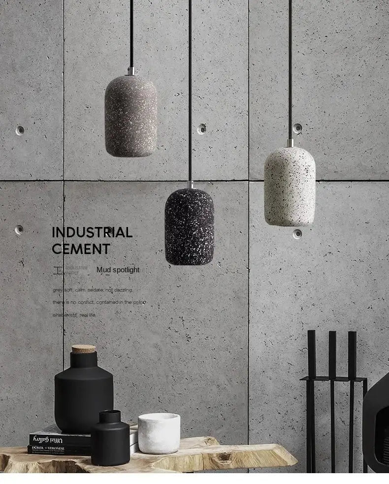 Three hanging pendant lamps in gray black and off-white textured cement finish for industrial style lighting