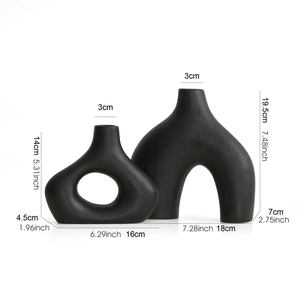 Two sleek matte black nordic ceramic vases with asymmetrical shapes for elegant vases home decor by decorbites
