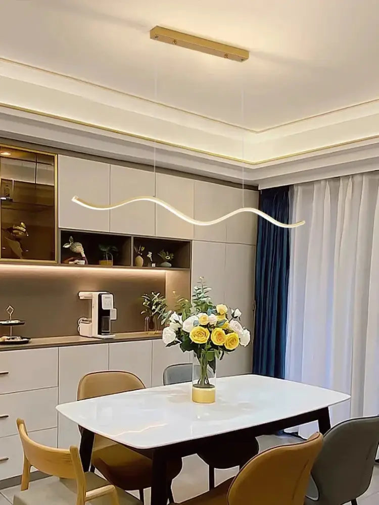 A modern white marble dining table with dark wooden legs paired with DecorBites™ nordic chandeliers for stylish dining room lighting