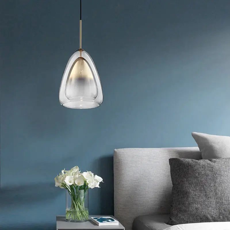 Decorbites nordic double glass cone pendant light fixture with clear glass and brass accents above bedside table