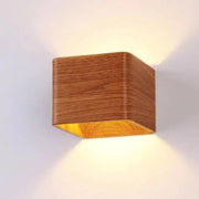 DecorBites™ nordic faux wooden cube wall sconce with warm-toned illuminated interior and natural grain finish