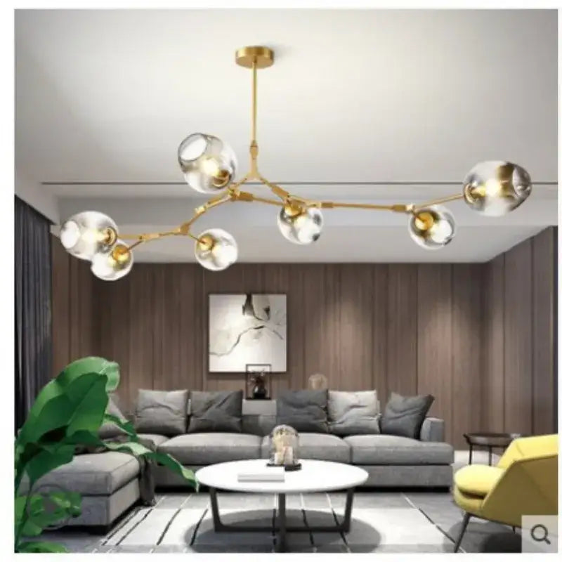 Gold-toned nordic glass ball led chandelier featuring clear glass globe bulbs in a black gold finish by decorbites