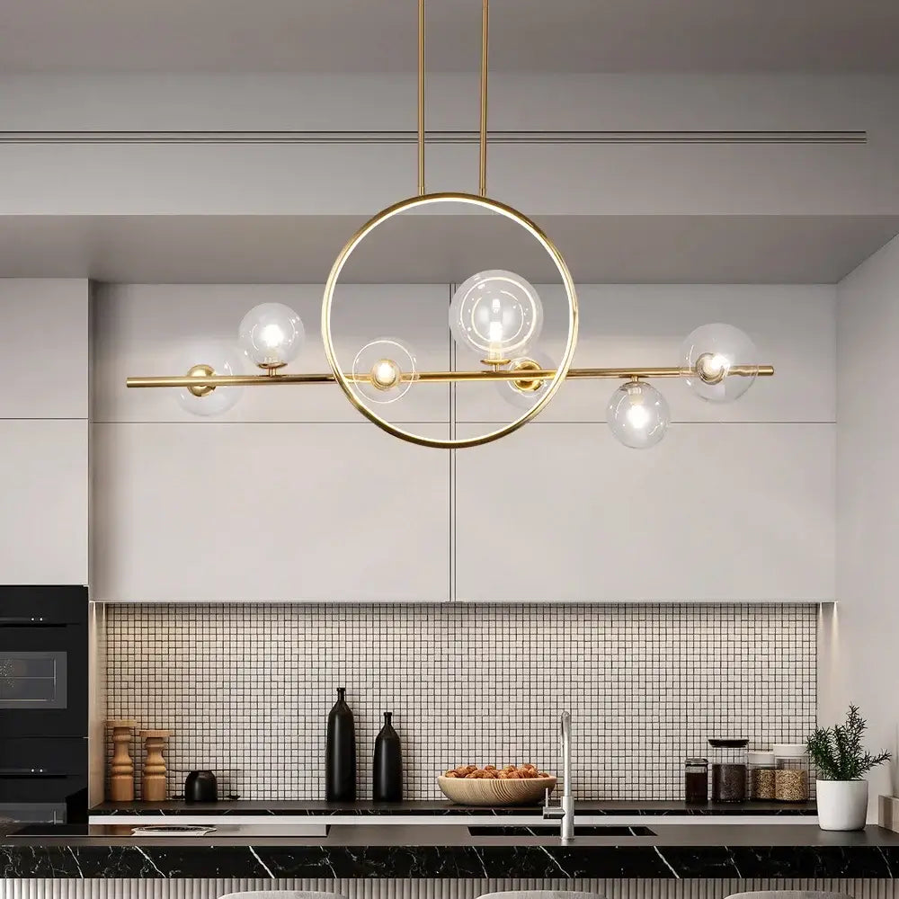 Gold-toned modern pendant light with circular frame and five clear glass bubble led globe bulbs in nordic style