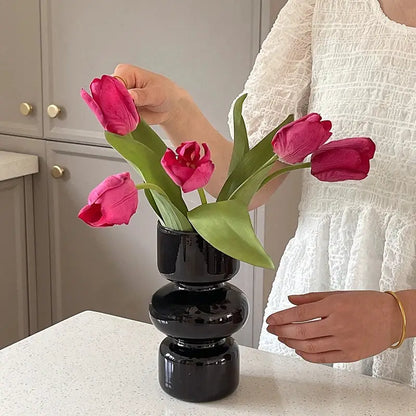DecorBites™ nordic glass vase home decor featuring a black glossy stacked design holding vibrant pink tulips