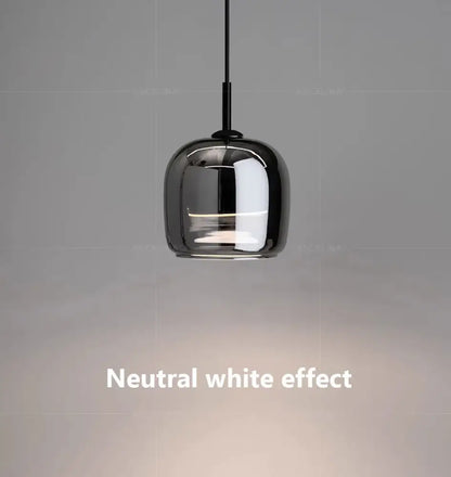 A sleek nordic glass led pendant chandelier with a glossy black glass shade and thin black cord by DecorBites™