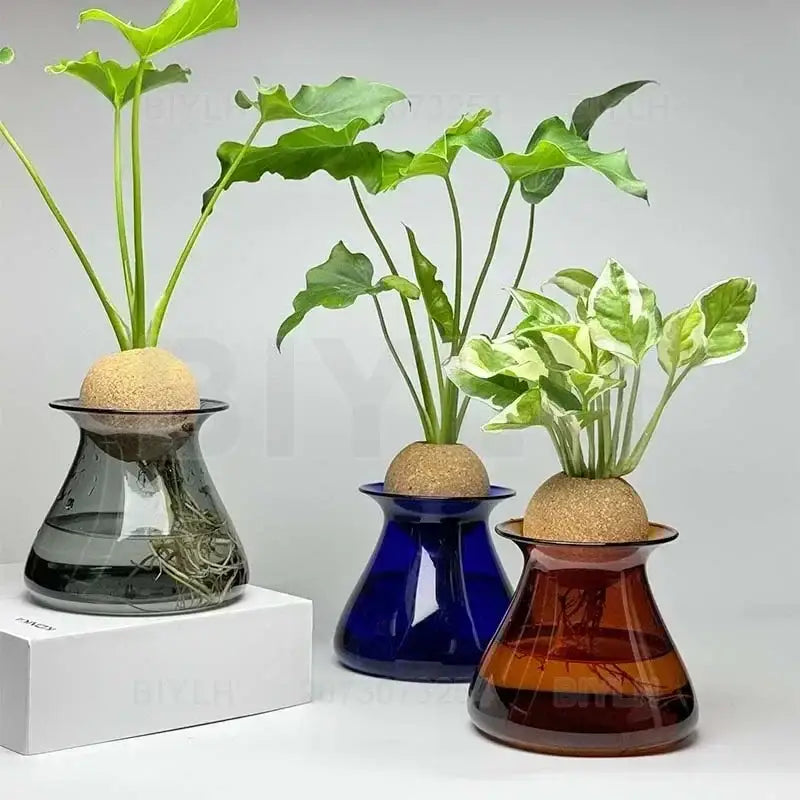 Three glass vases in dark gray deep blue and amber hues with plants and cork tops nordic glass vase for home decor