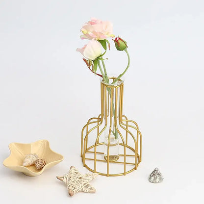DecorBites Nordic iron golden hydroponic vase with gold wireframe and clear glass holding pink and white roses