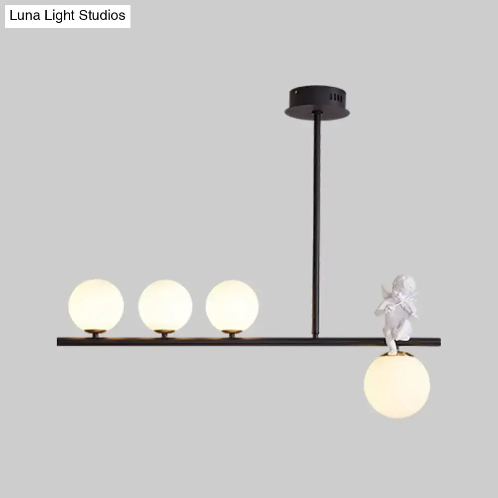 Black nordic island pendant light with opaline glass shade and white cherub figurine on frosted glass globes