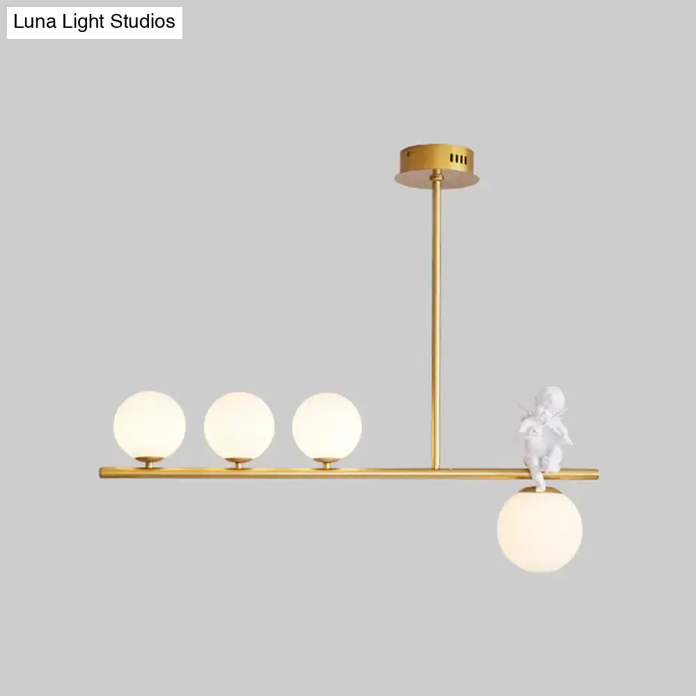 DecorBites Nordic island angel pendant light with gold-toned frame, opaline glass shade, and white cherub figurine