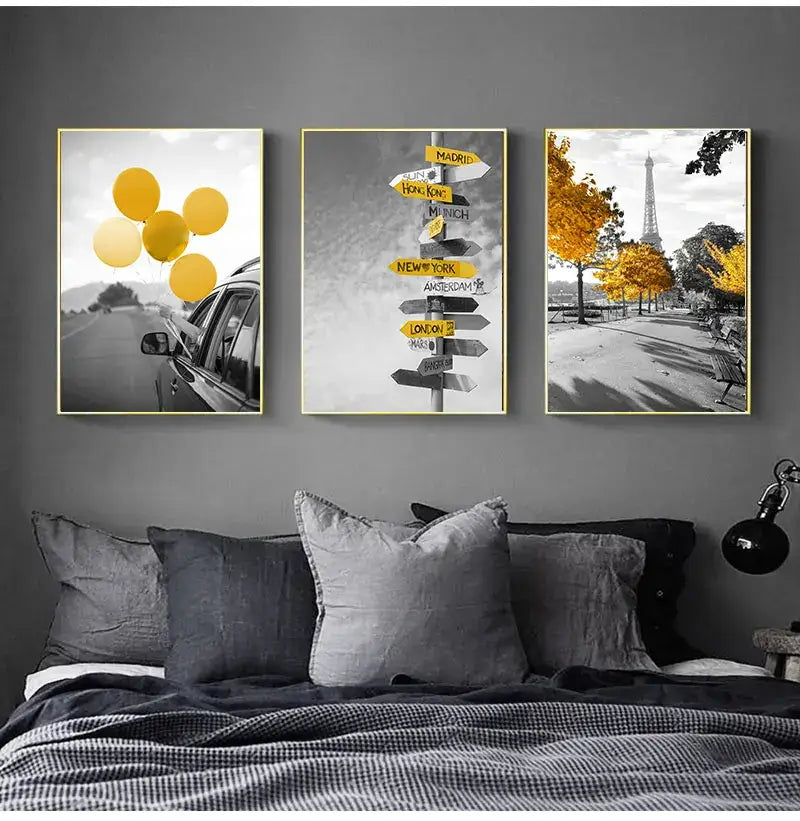 Three framed travel-themed nordic landscape canvas prints with gold frames featuring yellow scenery and autumnal scenes