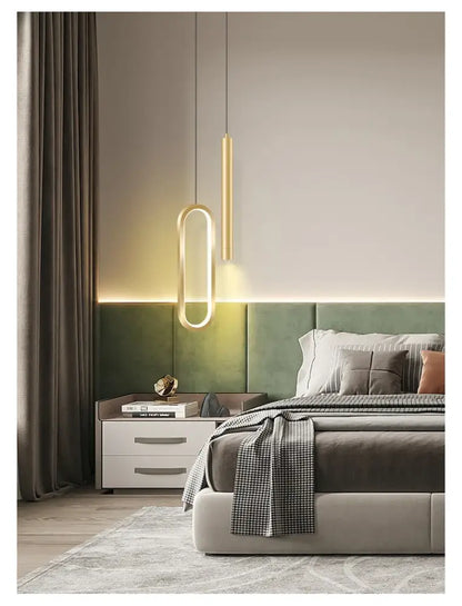 DecorBites™ Nordic led pendant light in gold tone with sleek elongated oval design hanging above the bed