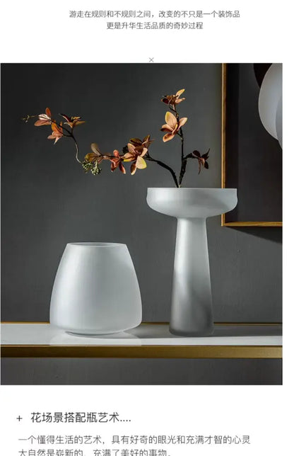 A sleek frosted glass vase by decorbites with a modern pedestal base and wide opening in white ceramic finish