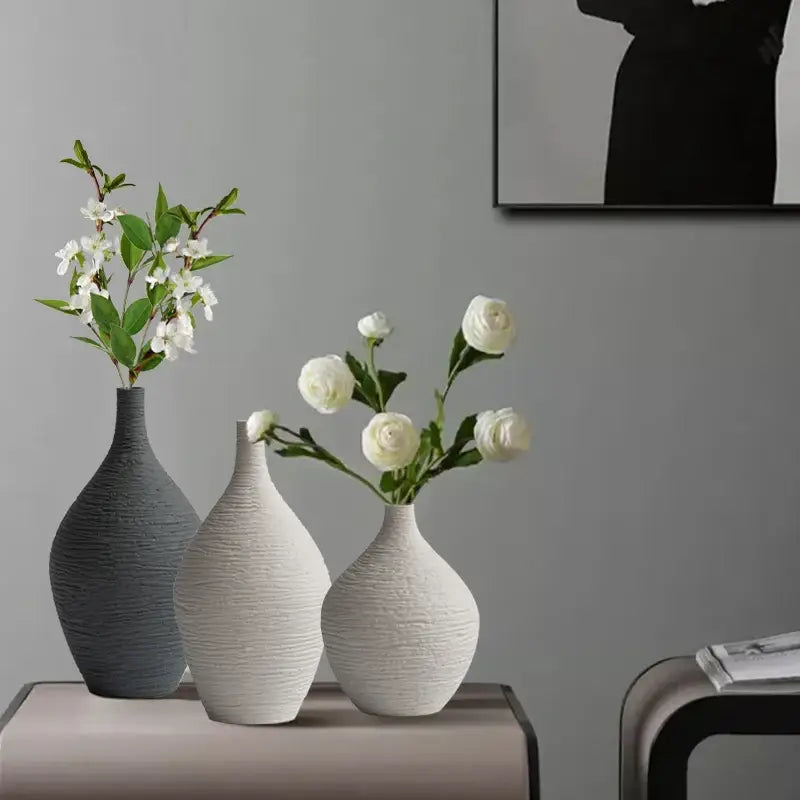Three textured ceramic vases in gray, white, and off-white with ribbed design for nordic luxury ceramic home décor by DecorBites