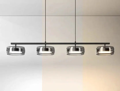 Modern black metal pendant lamp with four frosted glass shades emitting warm white light for dining and living rooms