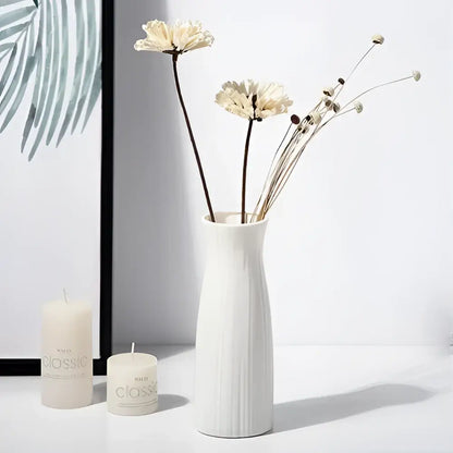 White ceramic nordic plastic vase with vertical ridged texture holding dried flowers for modern home decor