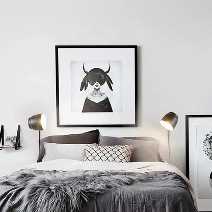 Black-framed monochrome artwork of a woman with horned headwear featured in DecorBites™ nordic plug-in wall sconce wall light