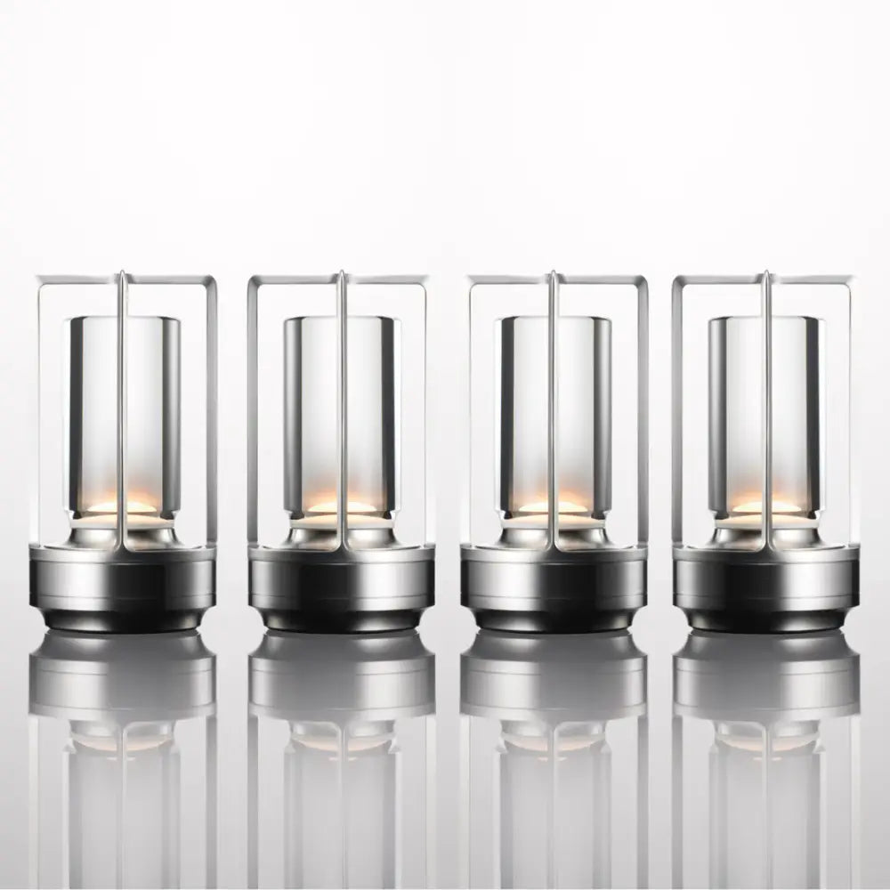 Four sleek nordic rechargeable table lamps with metallic frames and clear glass housing warm led lights by decorbites
