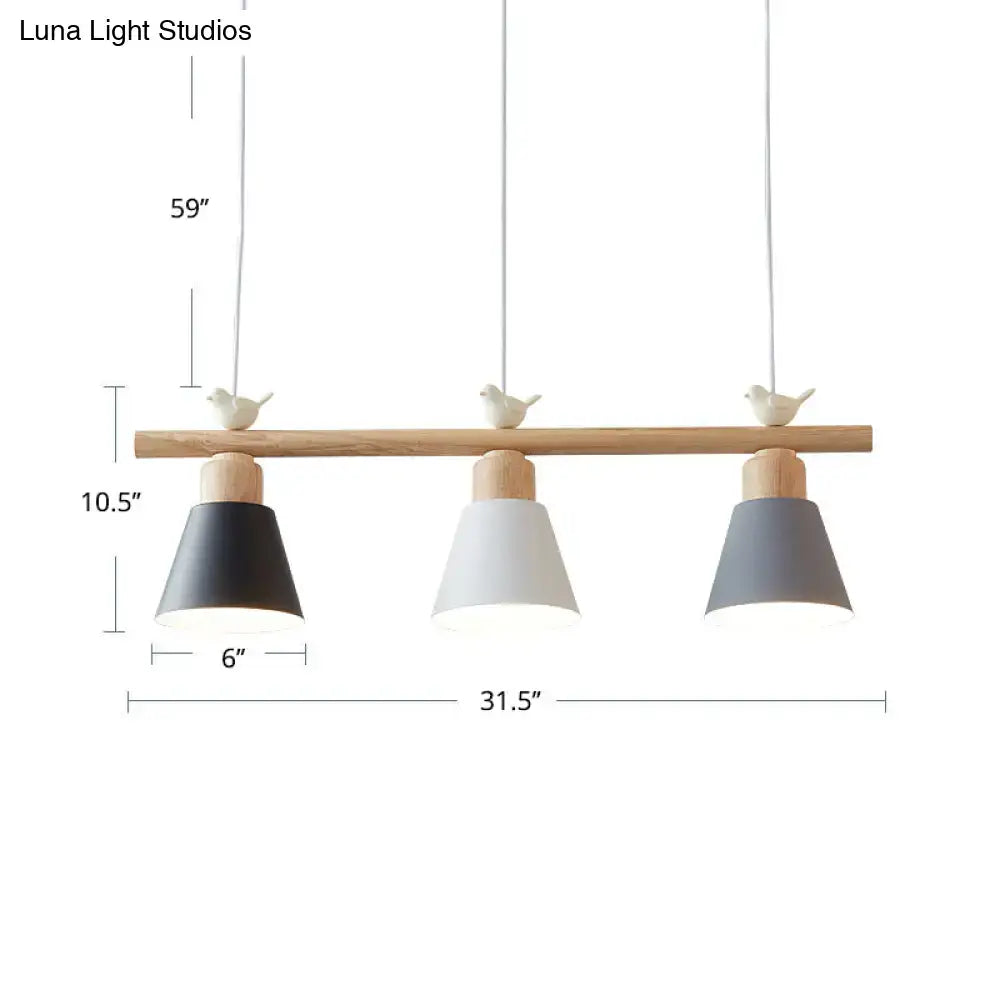 Minimalist three-light hanging island light with natural wood bar metal pendant shades in matte black white and gray with bird decor