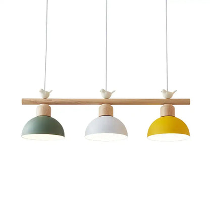Decorbites nordic metal hanging island light with three dome shades in sage green white and yellow on wooden bar