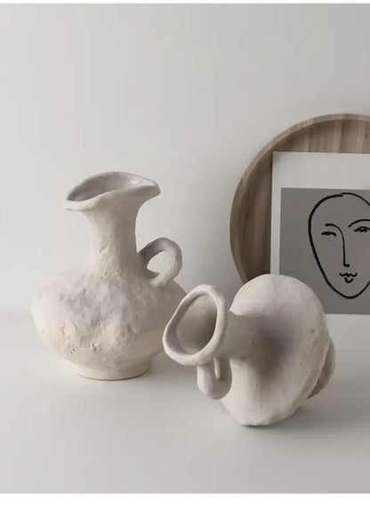 Cream-colored nordic style ceramic flower pot with textured handmade finish and integrated handle by decorbites