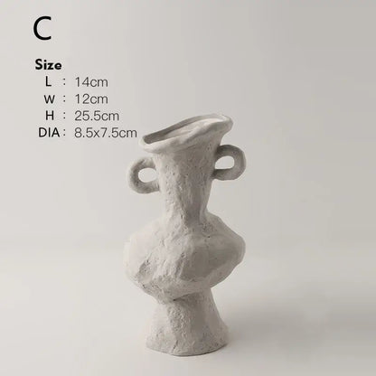 A textured off-white nordic style ceramic flower pot with two looped handles and an asymmetrical sculptural form by DecorBites