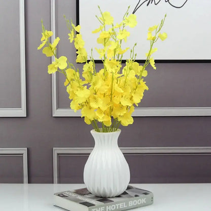 DecorBites™ nordic style white ceramic flower vase with ribbed texture holding bright yellow artificial flowers