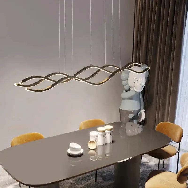 Modern gold-toned wave-shaped led pendant light with sleek curves for nordic style dining room chandeliers decorbites
