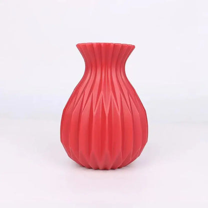 A vibrant red ribbed plastic flower vase with flared rim and geometric pattern for home decor by DecorBites™ Nordic style