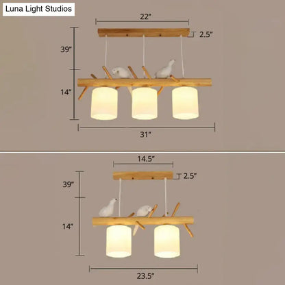 DecorBites™ Nordic wood pendant light with opal glass cylinder shades and resin bird decor on natural wood branches