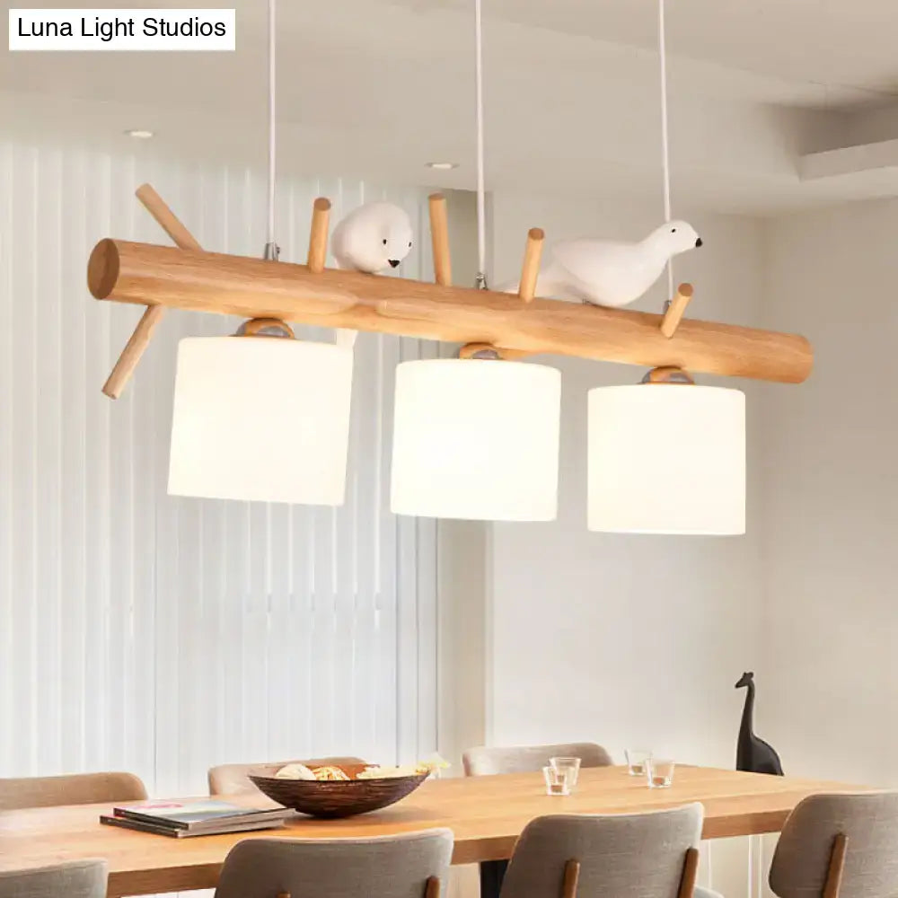 Decorbites nordic wood pendant light with opal glass cylinder shades and resin bird decor on minimalist wooden branch