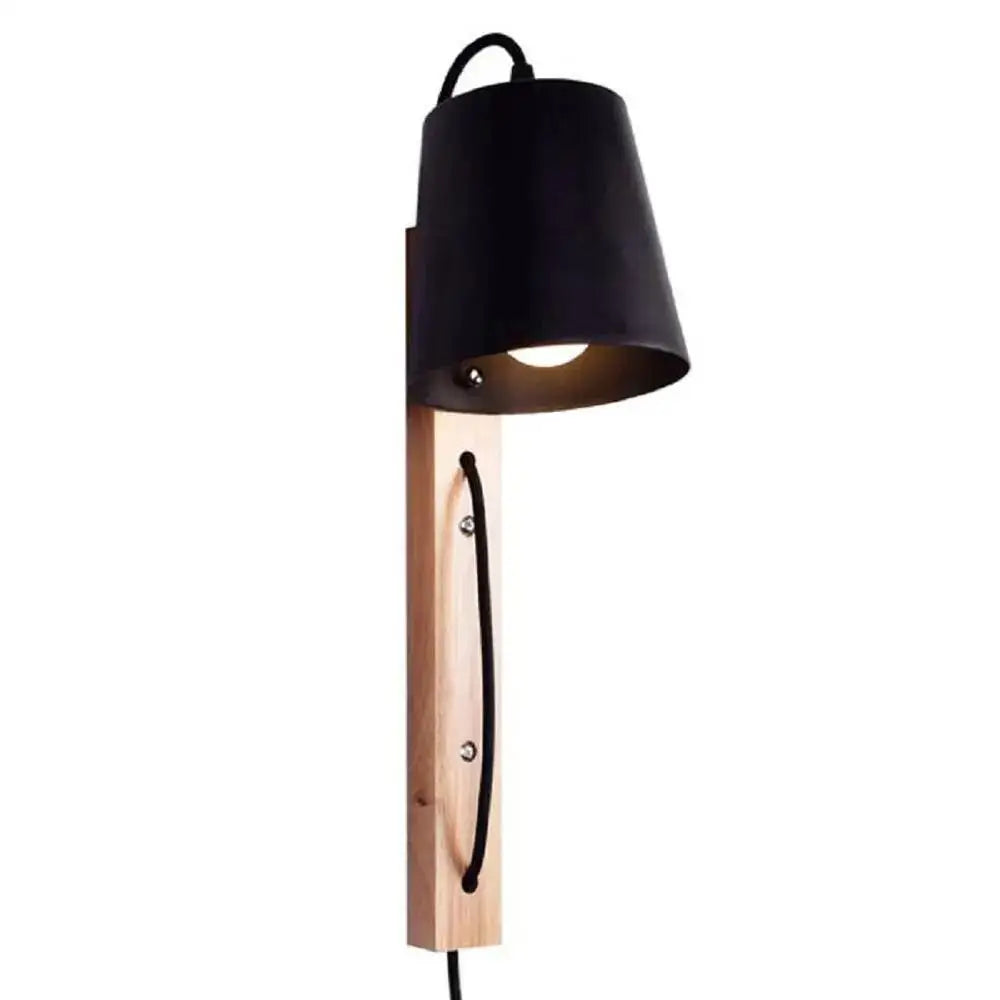 Black metal wall sconce with plug in design mounted on light wood plank featuring black cord detail from DecorBites Nordic Wood line