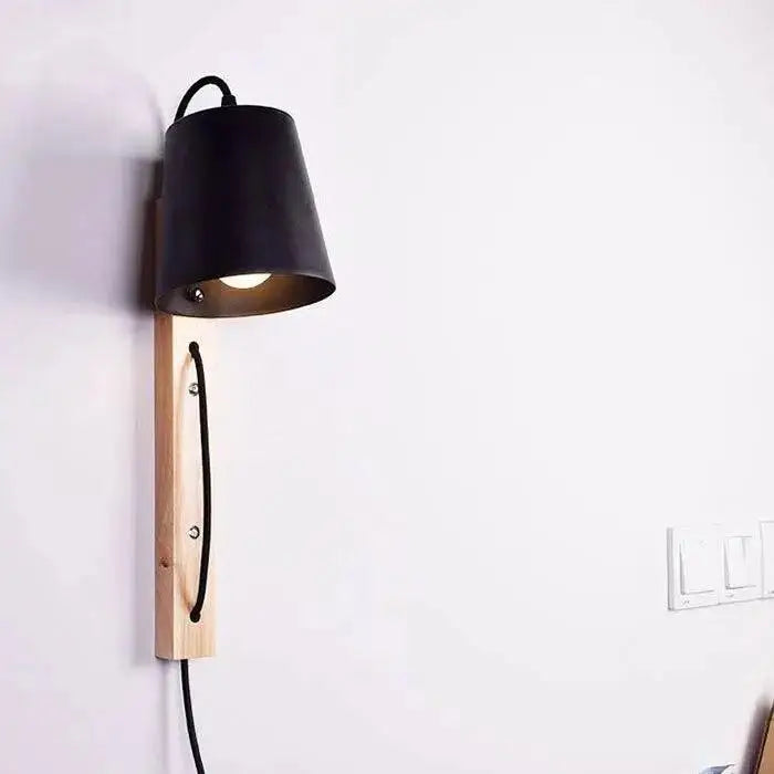 Black metal lampshade wall sconce mounted on light wood base with black cord for mida wall sconce decorbites nordic wood plug in
