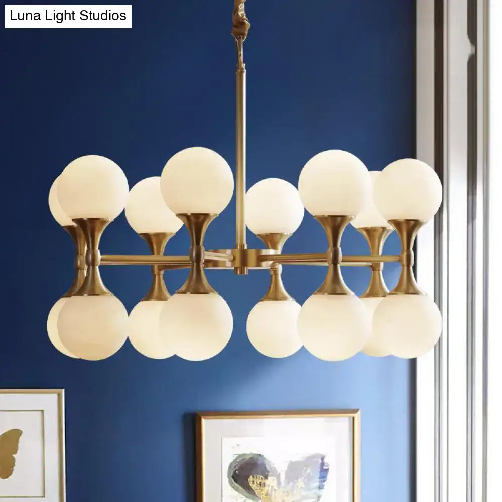Decorbites opal glass chandelier light with brass finish and multiple frosted globe heads in postmodern style