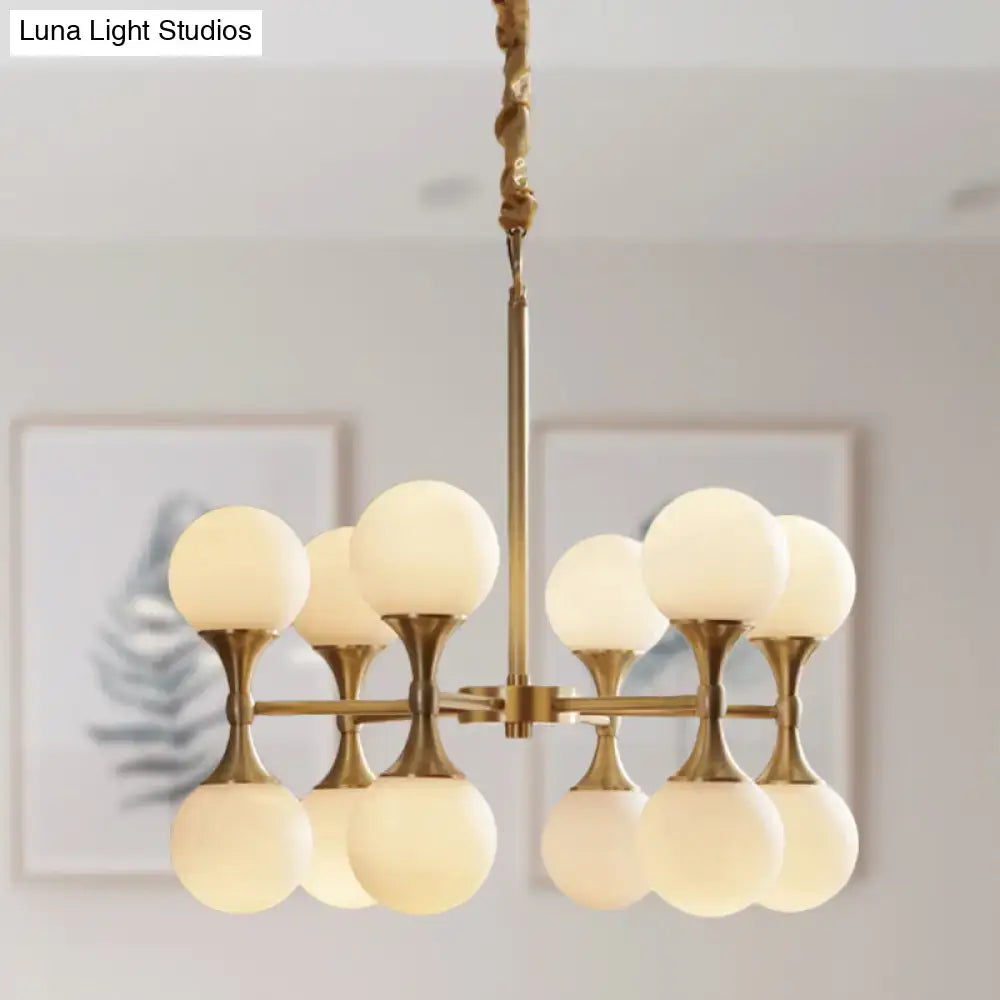 DecorBites opal glass chandelier light with gold-toned brass frame and eight frosted opal glass globe shades in two tiers