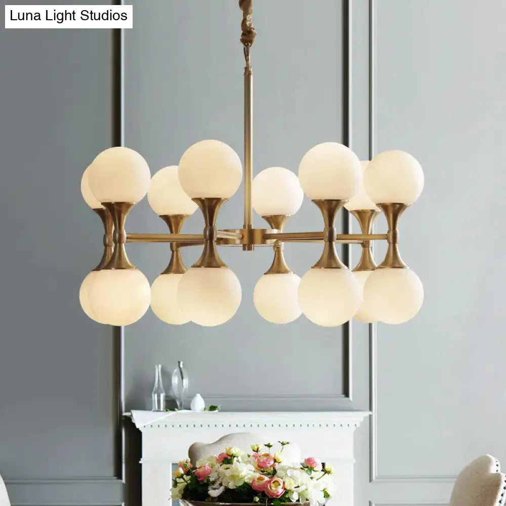 DecorBites opal glass chandelier featuring brass finish and 12 glass globe heads in a modern ceiling light design