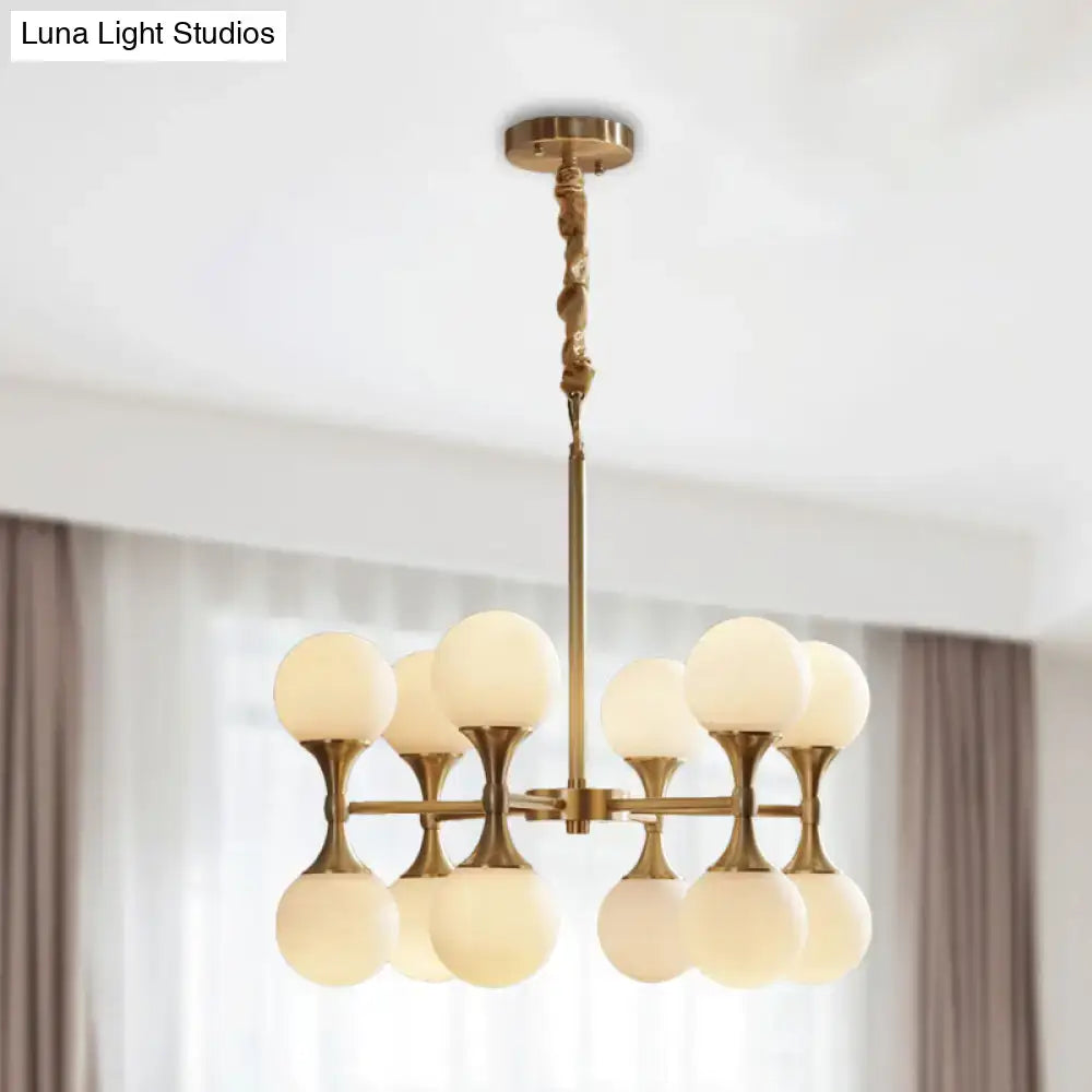 Brass-finished decorbites™ opal glass chandelier light with eight frosted globe shades arranged in two tiers