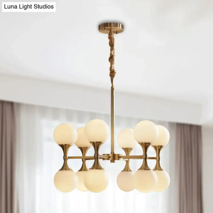 Brass-finished decorbites™ opal glass chandelier light with eight frosted globe shades arranged in two tiers